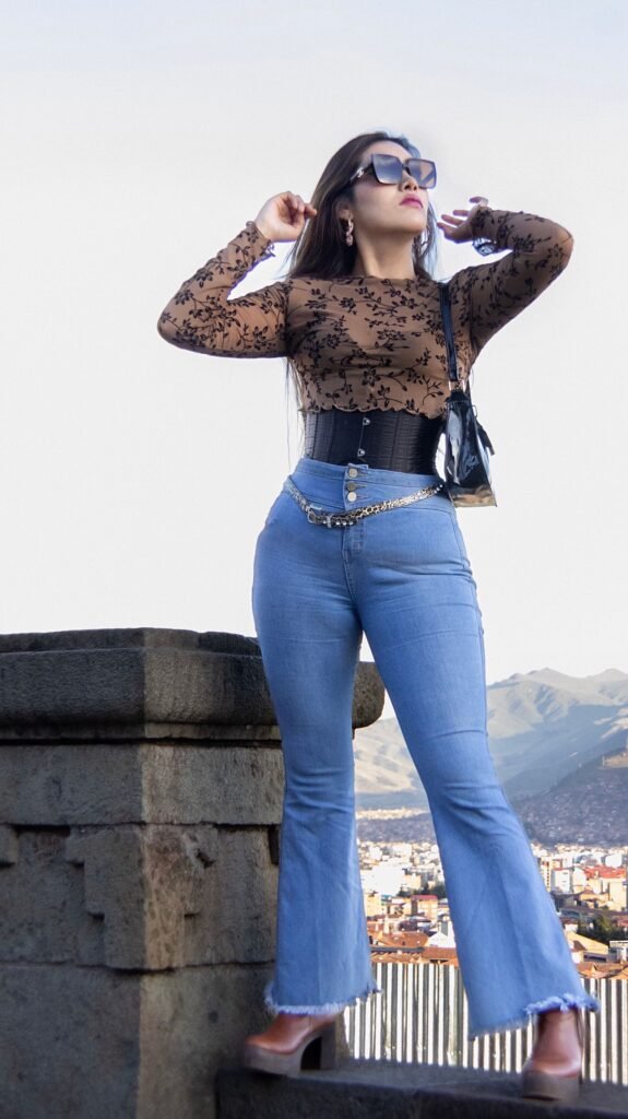 Woman wearing high-waisted flared jeans, illustrating the best jeans for a FUPA guide