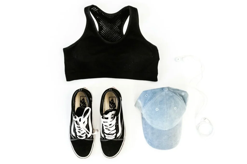 Sports bra, training shoes and gym accessories arranged as a flat lay