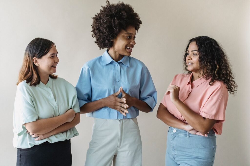 Group of diverse women smiling together, illustrating that having a FUPA is a normal, common variation